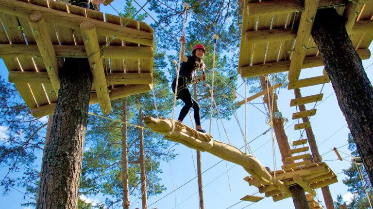 Girl on high wire climbing park in Norway