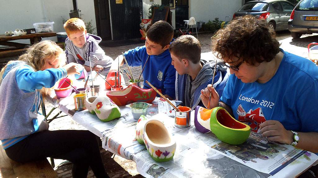 boys at a craft workshop and clog painting