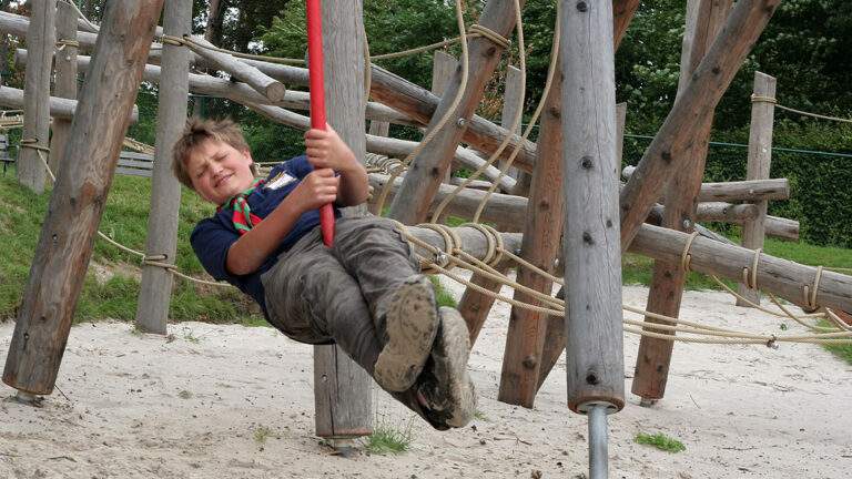 young boy on pioneering poles