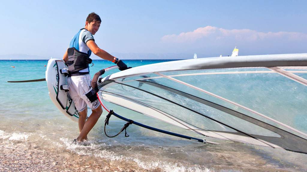 young person preparing to go windsurfing
