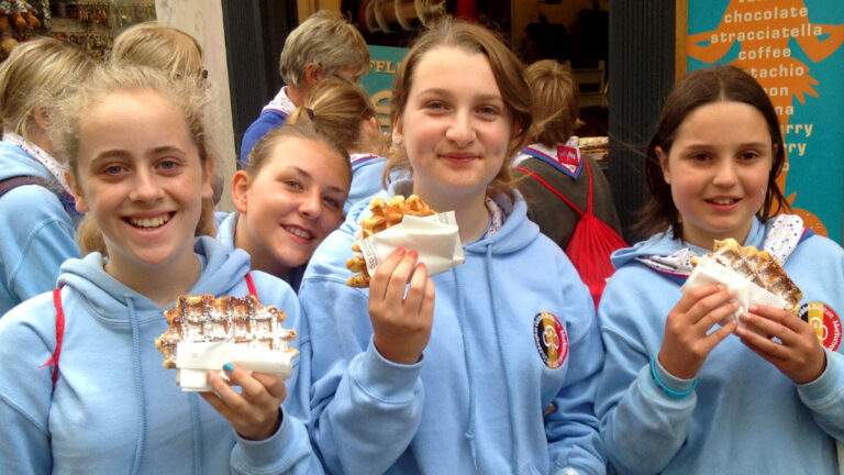 Group of girls eating waffles in Belgium