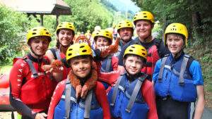 Group of boys posing for a photo after white water rafting on a scout trip