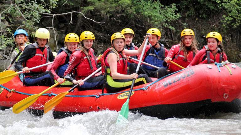 Group of children white water rafting