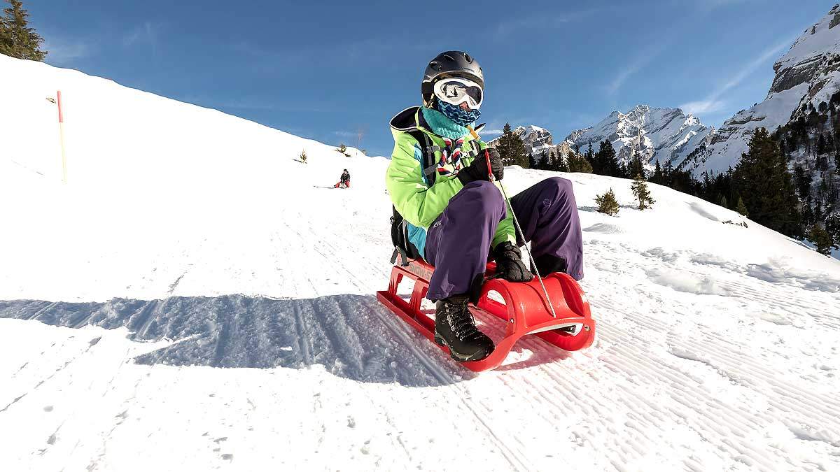 Young person sledging at Kandersteg in Switzerland