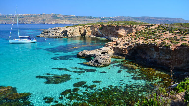 Yacht in Comino - Malta. Clear blue seas surrounding the island of Comino in Malta