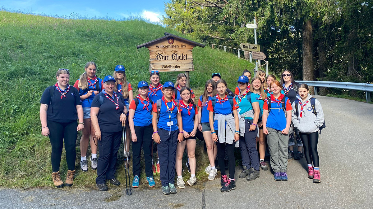 Herefordshire guides outside of Our Chalet near the sign