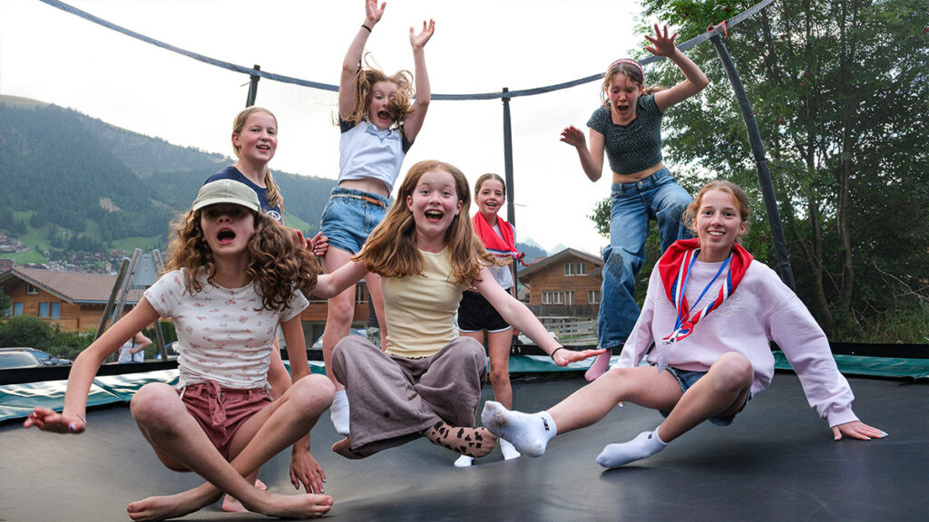 Hexham guides having fun on a trampoline in Adelboden