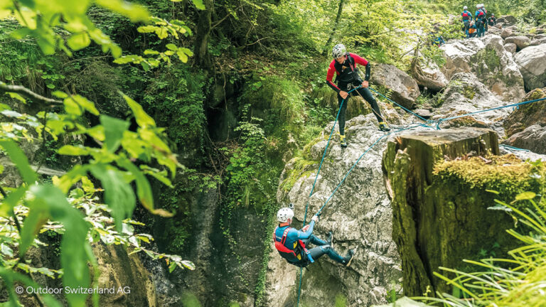 two people canyoning at Interlaken, Switzerland