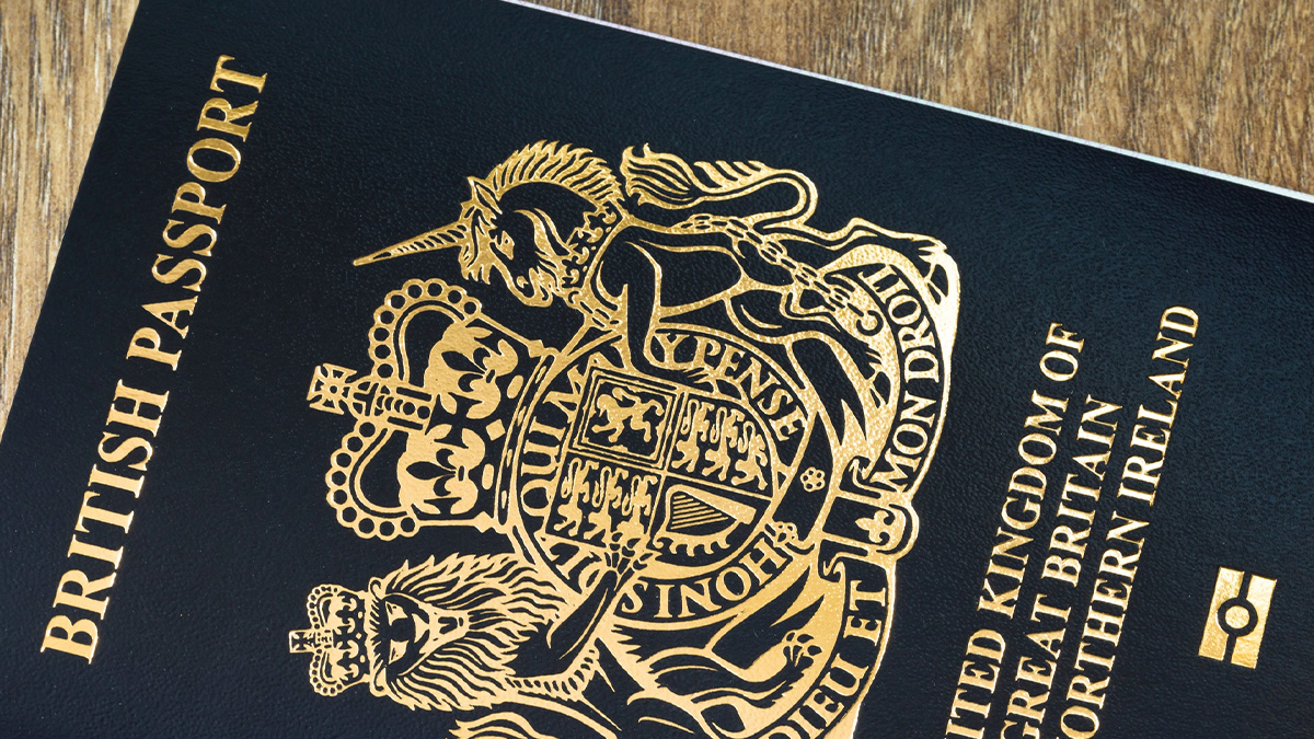 black British passport on wooden table