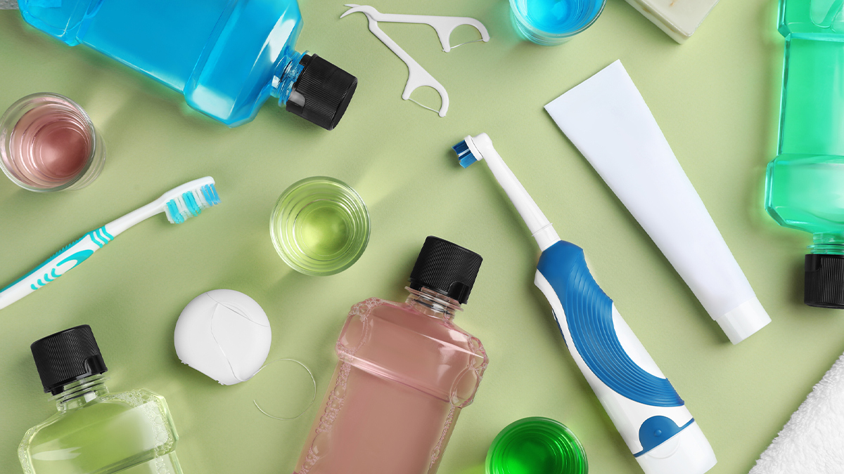 personal oral hygiene items on light green table