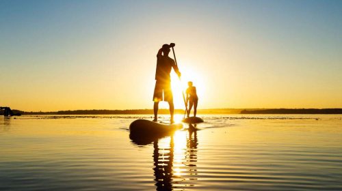 Stand-up paddle boarding at sunrise