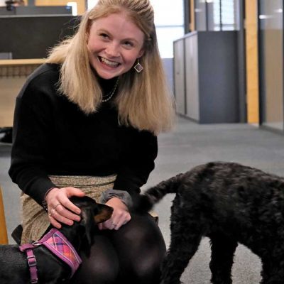 female petting dogs in an office