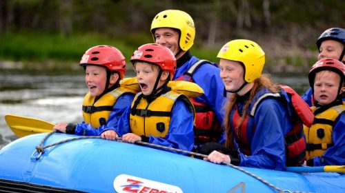 Young people white water rafting